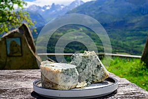 Pouring from high height of natural Asturian cider made fromÂ fermented apples, Asturian cabrales cow blue cheese with view on